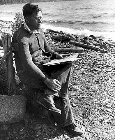 Black and white photograph of Elmer Benson by a lake, 1937. 