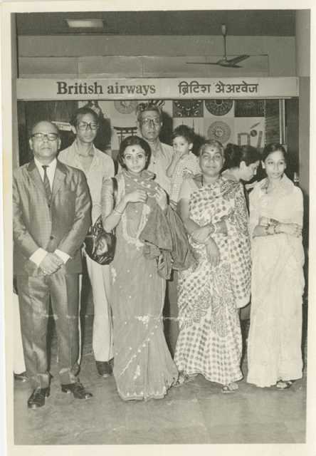 Black and white photograph of Preeti Mathur (first row, center left) at Bombay Airport in April 1978 with family on the eve of her departure to the United States. Used with the permission of Preeti Mathur. 