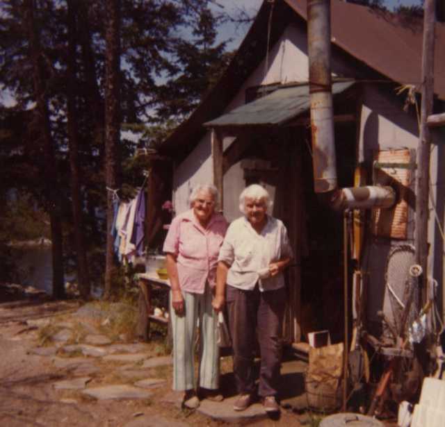 Color image of Dorothy Molter and Ruth Molter at Point Cabin, Isle of Pines, Knife Lake, Boundary Waters Canoe Area ca. 1980s.