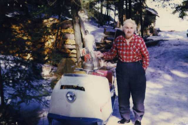 Color image of Dorothy Molter with her Polaris Mustang snowmobile, Isle of Pines, Knife Lake, Boundary Waters Canoe Area, ca. 1970s.