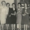 Black and white photograph of Mrs. Matzke, Miss Olson, and Miss Nelson present yellow carnations to initiates Luverne Sorenson, Deborah Hanson, Eloise Espe, and Clara Kelly at an initiation meeting for new BPWC members, 1966.