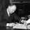 Black and white photograph of Harold Stassen signing a bill into law, 1941.
