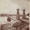 Black and white photograph of the Hennepin Bridge from Nicollet Island, c.1868.