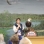 Color image of a National Eagle Center employee shows a bald eagle to visitors during a 2015 educational program.