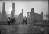 Black and white photograph of people and ruins after the fire, 1918.