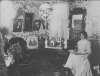 Black and white photograph of Susie Schmitt Hanson is seated wearing a light-colored long-sleeve floor-length dress.