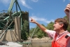 A worker points to a section of the collapsed I-35W bridge on August 3, 2017. Photograph by Kevin Rofidal (Edina Police Department).