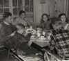 Black and white photograph of Governor Elmer Benson eating breakfast with his family at their cabin on the North shore of Lake Superior, 1937.  