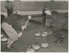 A curling game, 1937. Curling was introduced to Minnesota in the 1850s. Shown is action ca. 1935.