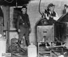 Black and white photograph of police destroying an illegal alcohol still during Prohibition, 1925. Photographed by the St. Paul Daily News.