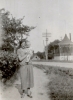 Black and white photograph of a woman and baby posing in front of the band shell in Hanover, ca. 1925–1930.