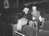 Black and white photograph of Charles and Louise Hiller sitting in theater seats, ca. 1940s.