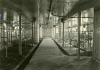 Black and white photograph of the inside of the dairy barn at the Northwest Experiment Station.   