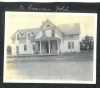 Photograph of the front of the Riverside Hotel, sometimes called the St. Francis Hotel. Four people stand or sit on the porch. Anoka County Historical Society, Object ID# JE0038-2. Used with the permission of Anoka County Historical Society.