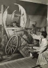 Black and white photograph of artist John Socha at work on a Works Progress Administration mural at the New Ulm High School, 1941. 