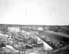 Black and white photograph of Swede Hollow with the Sixth Street Bridge in the background, c.1900.