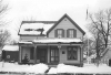 Black and white photograph of Sinclair Lewis’ childhood home, December 1975. Photographed by Henry Harren.