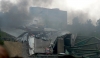 First responders next to the smoking wreckage of the bridge. Photo taken by Wikimedia Commons user Tony Webster, August 1, 2007. CC-BY-2.0