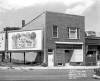 Boarded-up commercial building at 1418 Glenwood Avenue, ca. 1958. The image also shows a billboard advertising Wonder Bread. Photo by Norton & Peel.