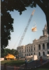 Color image of a construction crane lifting the quadriga into place over the Minnesota State Capitol's front entrance, June 21, 1995. Photographed by Linda A. Cameron