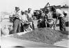 Black and white photograph of WPA crew mixing grasshopper bait for distribution to farmers, State Highway Maintenance Shops at Hopkins, 1937. 