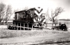 Black and white photograph of en turning a diesel locomotive on the Chicago, St. Paul, Minneapolis & Omaha turntable, ca. 1950s or 1960s.