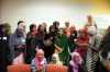 Color image of participants in a leadership development program gather around Malala Yousafzai (at center, in green) at the Confederation of Somali Community in Minnesota in August 2016.