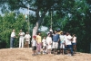 Color image of picnic attendees in St. Paul raise the national flag of India at an event held to celebrate India’s independence from Great Britain. Photographed by Anoop Mathur in August 2003.