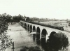 Train on the Stone Arch Bridge crossing the Mississippi River, Minneapolis; mill