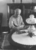 Black and white photograph of Charles Lindbergh in the living room of his restored boyhood home, 1971.