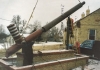Color image of the world’s largest peace pipe, photographed during installation next to the Rock Island Depot in Pipestone, 1998. 