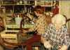 Color image of Dorothy Molter and John Kimbler bottling root beer, Isle of Pines, Knife Lake, Boundary Waters Canoe Area, ca. 1970s.