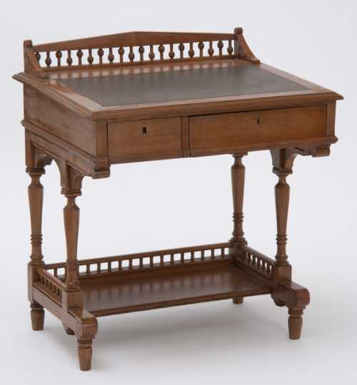 Color image of a small maple sloping lid desk used by the Minnesota state Legislature, ca. 1882.