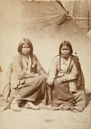 Black and white photograph of two Dakota women at the Fort Snelling concentration camp, c.1862–1863. Photograph by Joel Emmons Whitney.