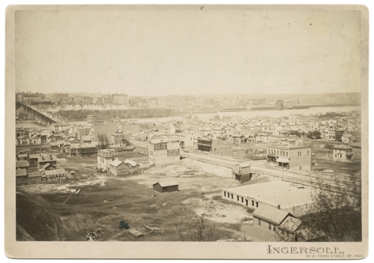 Black and white photograph of the lower West Side and Wabasha Bridge, c.1885. 