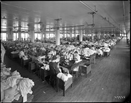 photograph of a room full of women at sewing machines
