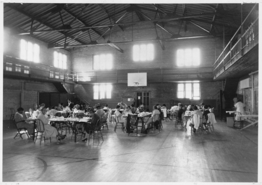 Black and white photograph of a sewing project at Phyllis Wheatley House, 1936.