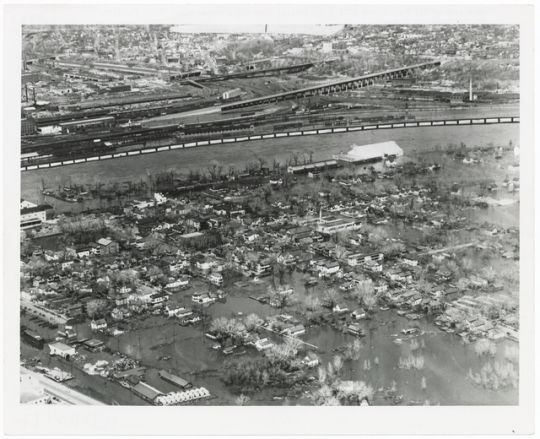 Black and white aerial view of West Side during flood, 1952.