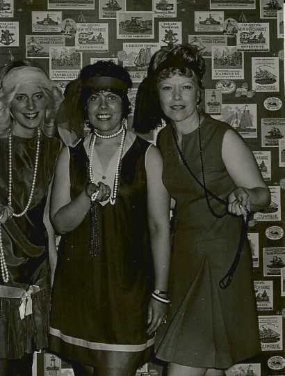 Black and white photograph of BPW members in 1920s flapper dresses at a holiday party, 1975.
