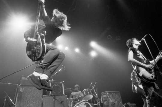 Black and white photograph of the Replacements performing at First Avenue, ca. 1985. Photograph by Daniel Corrigan.
