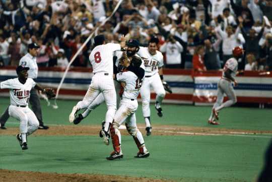 Twins relief pitcher Jeff Reardon is mobbed by catcher Tim Laudner and third baseman Gary Gaetti after the final out in the deciding Game Seven.