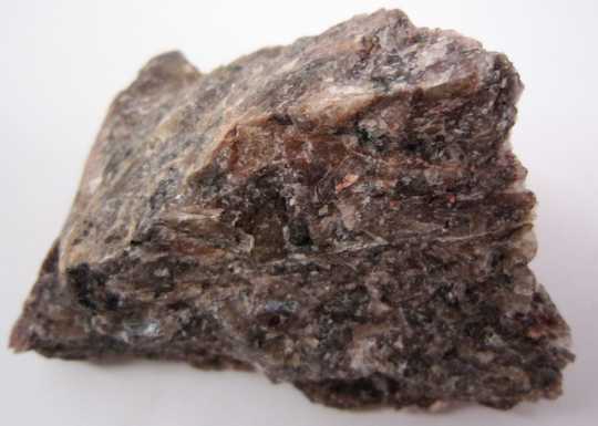 This sample of anorthosite was mined by 3M in the corporation’s earliest era. The corporation intended to mine corundum for sandpaper manufacturing, but anorthosite was found instead. This led to a transformation in the corporation’s structure and a transition from mining to manufacturing.