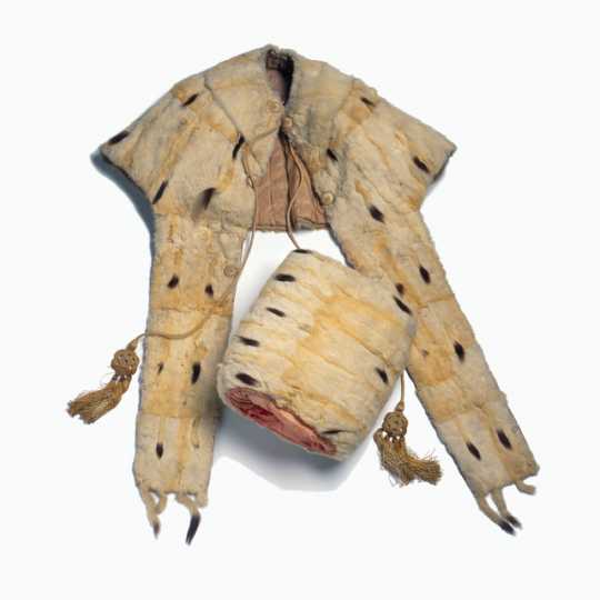 Color image of woman's white ermine tippet and muff set made c.1840.