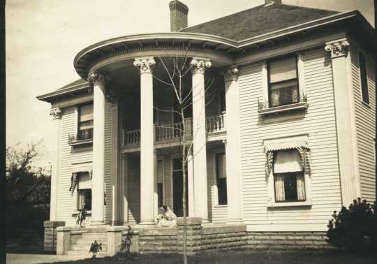 Colonial Hall (1900 3rd Avenue South, Anoka), date unknown. This was the home of Dr. Alanson Aldrich and Dr. Flora Aldrich. Alanson was an avid hunter and kept several hunting dogs in a kennel behind the house, two of which can be seen on the porch in this photograph. Photographer and date unknown. This photograph was found in the 1960s in the home of Era M. Smith, a friend of Dr. Flora Aldrich. Used with the permission of the Anoka County Historical Society.