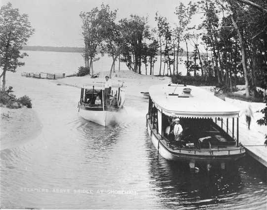 photograph of two boats on a river