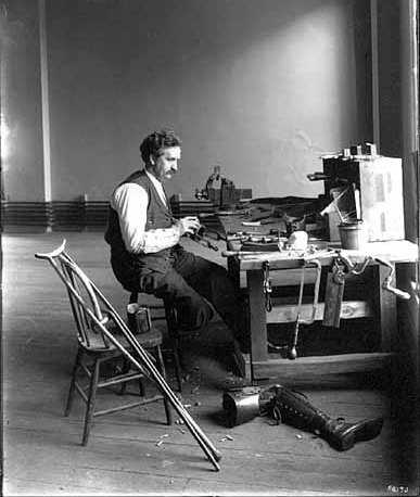 Black and white photograph of E. H. Erickson making artificial limbs, 1904.