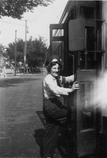 Photograph of motorette boarding a streetcar