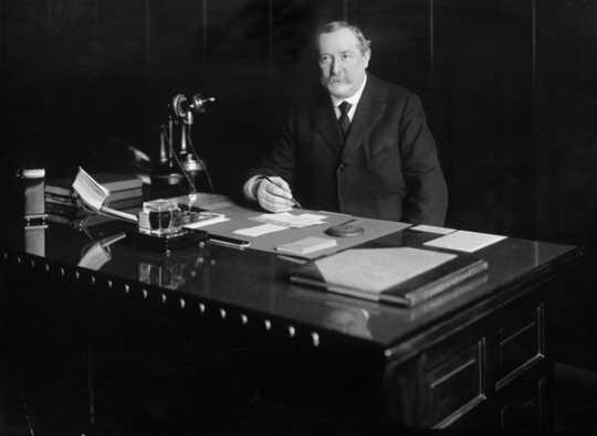 Black and white photograph of Lawrence S. Donaldson at his desk, c.1920. Photograph by C.J. Hibbard. 