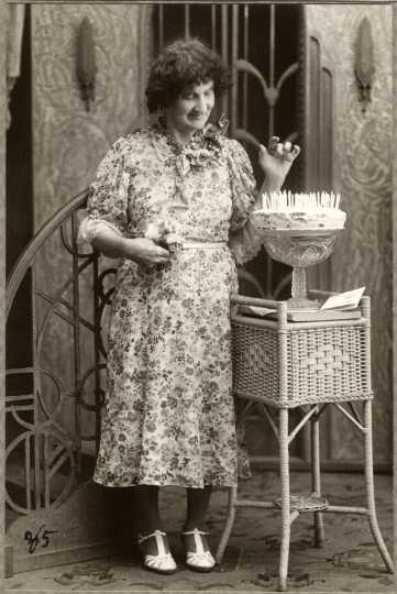 Black and white photograph of Susie Schmitt Hanson pictured at age eighty-five with a birthday cake, c.1945.