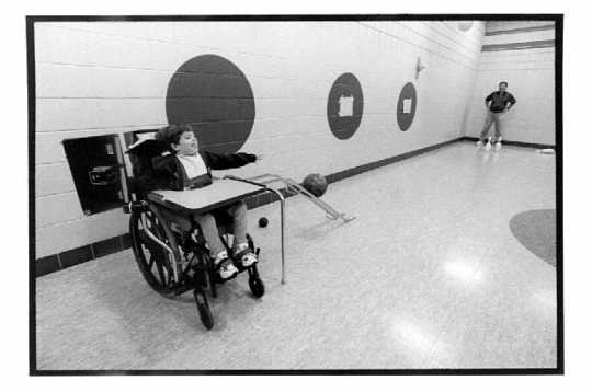 Third grader training for the Special Olympics bowling competition with her adaptive physical education teacher, Joe Mangini, at Cuyuna Range Elementary School in Crosby, Minnesota, 1998.